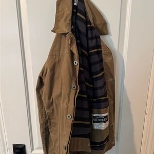 FLINT AND TINDER
Flannel-Lined Waxed Trucker Jacket